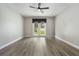 Bedroom featuring a ceiling fan, light gray walls, white trim, light wood-look flooring, and French doors at 3212 Preserve Dr, Orlando, FL 32824