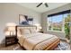 Comfortable bedroom features a large window and neutral decor, creating a relaxing atmosphere at 3212 Preserve Dr, Orlando, FL 32824