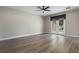 Bedroom featuring a ceiling fan, light gray walls, white trim, light wood-look flooring, and a set of French doors at 3212 Preserve Dr, Orlando, FL 32824