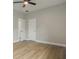 This bedroom features a ceiling fan, white trim, light gray walls, and light wood-look flooring at 3212 Preserve Dr, Orlando, FL 32824