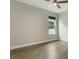 Bedroom with laminate floors, a ceiling fan, and a window overlooking the backyard at 3212 Preserve Dr, Orlando, FL 32824