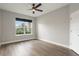 Bedroom with laminate floors, ceiling fan, and a large window overlooking the backyard at 3212 Preserve Dr, Orlando, FL 32824