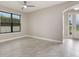 Neutral bedroom with a large window providing ample natural light and tile flooring at 3212 Preserve Dr, Orlando, FL 32824
