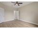 Bedroom featuring modern ceiling fan, laminate floors, and a connecting door to another room at 3212 Preserve Dr, Orlando, FL 32824
