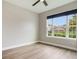 Bedroom with laminate floors, a ceiling fan, and a large window with views of the neighborhood at 3212 Preserve Dr, Orlando, FL 32824