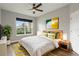 Well-lit bedroom features a large window, hardwood floors, and neutral decor for a calming retreat at 3212 Preserve Dr, Orlando, FL 32824