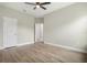 This bedroom has a ceiling fan, white trim, light gray walls, light wood-look flooring, and two doors at 3212 Preserve Dr, Orlando, FL 32824