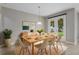 A dining room includes a table set for six people and a view of the backyard at 3212 Preserve Dr, Orlando, FL 32824
