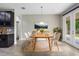 Bright dining room with wood table, modern chairs, and glass patio doors providing outdoor views at 3212 Preserve Dr, Orlando, FL 32824