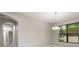 Dining room featuring modern chandelier and a large window with green views at 3212 Preserve Dr, Orlando, FL 32824