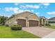 Well-maintained two-car garage home, featuring a paver driveway, and lush lawn at 3212 Preserve Dr, Orlando, FL 32824