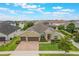 Beautiful single-Gathering home with 3-car garage, brick paver driveway, and meticulously maintained landscaping at 3212 Preserve Dr, Orlando, FL 32824