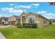 Charming one-story home with a well-manicured lawn and brown two car garage doors at 3212 Preserve Dr, Orlando, FL 32824