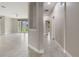 Bright hallway with tile floors leading to the living area and bedrooms of the home at 3212 Preserve Dr, Orlando, FL 32824