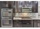 Close up view of kitchen with stainless steel appliances and modern backsplash at 3212 Preserve Dr, Orlando, FL 32824