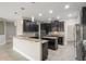 A kitchen features granite countertops, backsplash, an island, and stainless steel appliances at 3212 Preserve Dr, Orlando, FL 32824