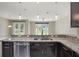 Kitchen featuring granite countertops, stainless steel sink and view to the backyard at 3212 Preserve Dr, Orlando, FL 32824