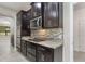 Stylish kitchen with dark cabinetry, stainless steel appliances, and granite countertops at 3212 Preserve Dr, Orlando, FL 32824