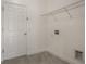 Bright laundry room with tile flooring, a metal shelf and washer/dryer hookups at 3212 Preserve Dr, Orlando, FL 32824