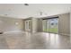 Spacious living room with tile flooring and double French doors leading to the backyard at 3212 Preserve Dr, Orlando, FL 32824