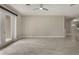 Open living room with tile flooring, neutral paint, and arched entryway to a dining area at 3212 Preserve Dr, Orlando, FL 32824
