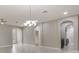 Spacious living area with arches and tile flooring, showcasing an open concept design at 3212 Preserve Dr, Orlando, FL 32824