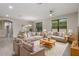 An open-concept living room with multiple sofas and abundant natural light at 3212 Preserve Dr, Orlando, FL 32824