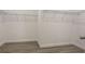 Spacious walk-in closet features wood laminate flooring and wire shelving for ample storage at 3212 Preserve Dr, Orlando, FL 32824