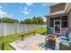 Landscaped backyard offers a private retreat with patio space, bench, and white vinyl fence at 3221 Bayflower Ave, Harmony, FL 34773