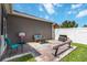 Backyard area includes a patio with seating, a grassy area, and a white vinyl fence at 3221 Bayflower Ave, Harmony, FL 34773