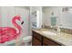 Bathroom featuring a flamingo shower curtain, granite countertops, and white cabinets at 3221 Bayflower Ave, Harmony, FL 34773
