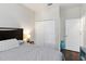 Comfortable bedroom featuring a large closet, neutral color palette, and wood-look flooring at 3221 Bayflower Ave, Harmony, FL 34773