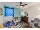 bedroom featuring hardwood floors, ceiling fan and comfortable rocking chair at 3221 Bayflower Ave, Harmony, FL 34773