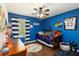 Vibrant bedroom with blue walls, window, ceiling fan, and fun decor offers a comfortable retreat at 3221 Bayflower Ave, Harmony, FL 34773