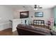 This bonus room includes a ceiling fan, TV, furniture, and offers versatile space for relaxing and entertaining at 3221 Bayflower Ave, Harmony, FL 34773