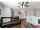 This upstairs bonus room features hard surface floors, a ceiling fan, natural light, and comfortable seating at 3221 Bayflower Ave, Harmony, FL 34773