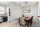 Cozy dining area features a pendant light fixture and a view of the kitchen and backyard at 3221 Bayflower Ave, Harmony, FL 34773
