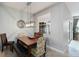 Bright dining room features updated light fixture, large windows, and access to the living area and backyard at 3221 Bayflower Ave, Harmony, FL 34773
