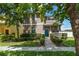 Inviting two-story home features manicured lawn, front porch, and well-maintained landscaping at 3221 Bayflower Ave, Harmony, FL 34773