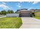 Spacious two-car garage with a long driveway and well-maintained lawn at 3221 Bayflower Ave, Harmony, FL 34773