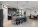 Kitchen featuring an island with seating, tile backsplash, and stainless-steel appliances at 3221 Bayflower Ave, Harmony, FL 34773