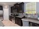 Updated kitchen with stainless steel appliances, tile backsplash, and granite countertops at 3221 Bayflower Ave, Harmony, FL 34773