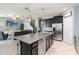 Open-concept kitchen with island, stainless-steel appliances, and seamless flow to the living area at 3221 Bayflower Ave, Harmony, FL 34773