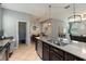 Open kitchen area with large granite island, stainless steel dishwasher, and views to dining and living room at 3221 Bayflower Ave, Harmony, FL 34773