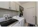 Spacious laundry room has cabinetry, beadboard accents, and washer and dryer hookups at 3221 Bayflower Ave, Harmony, FL 34773