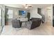 Open living room with tile flooring, large windows, and comfortable seating arrangement at 3221 Bayflower Ave, Harmony, FL 34773