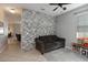 Comfortable living room with a stylish accent wall and tile flooring at 3221 Bayflower Ave, Harmony, FL 34773