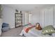Bedroom with carpet, a tiger toy, a bookshelf, and a white closet at 33 Peterlee Ct, Kissimmee, FL 34758