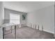 Bedroom featuring neutral walls, carpet, and a large window with blinds at 33 Peterlee Ct, Kissimmee, FL 34758