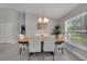Bright dining room with natural light, modern chandelier, and a view of the outdoor scenery at 33 Peterlee Ct, Kissimmee, FL 34758